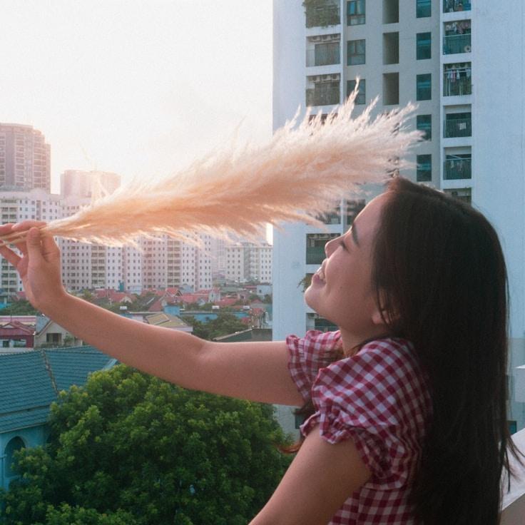 Kaveri Mehta, Lead Design Curator at Lumen Market Leaf, reviewing corporate floral arrangements